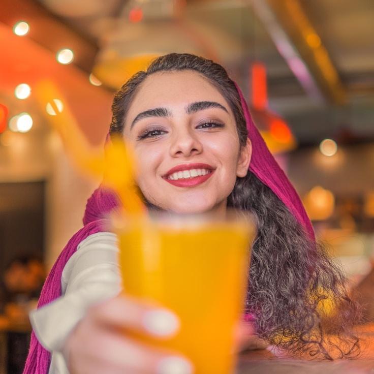 Kaveri Mehta, Lead Design Curator at GoldenBridgeHub, reviewing corporate floral arrangements